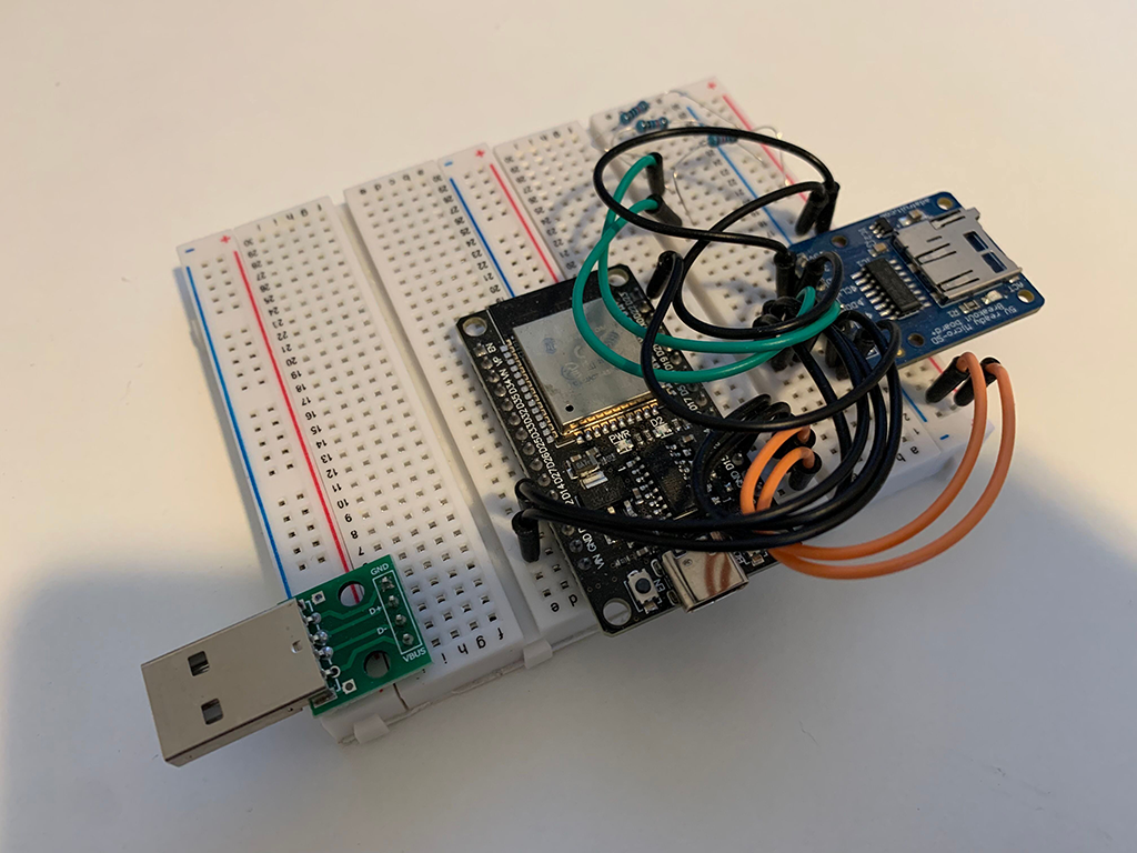 ESP32 on a breadboard connected with a SD card slot and USB-A male connector module