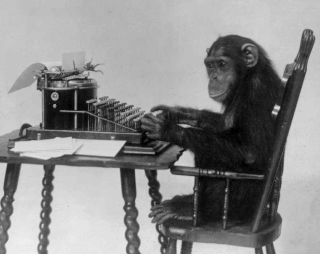 A chimpanzee seated at a typewriter.